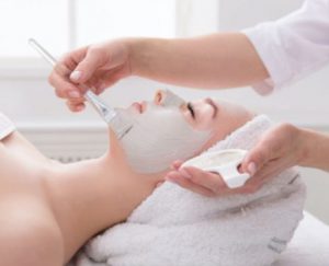 women with clay mask facial